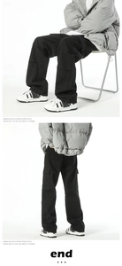 Detail of loose wide-leg cargo pants with large side pockets and retro street style