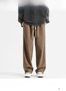 Detail of brown corduroy wide-leg pants featuring elastic waist and white drawstring