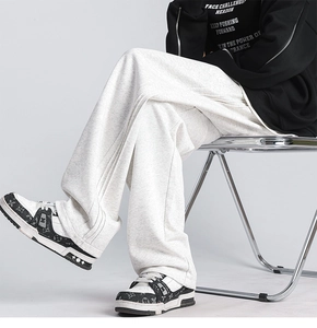 Detail view of white wide-leg sweatpants featuring soft knit fabric and drape silhouette