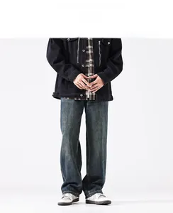 Detail of dark blue vintage wash denim jeans showing texture and relaxed straight-leg fit