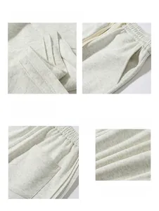 Detail view of heather grey sweatpants showing elastic waistband, pockets and fabric texture