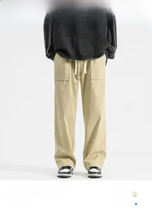 Detail of khaki wide-leg casual pants featuring large utility pockets and white drawstring