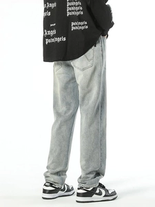Men's light blue straight-leg washed jeans with vintage distressed finish and back pockets