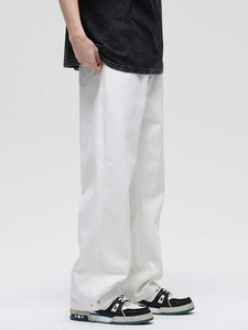Men's wide-leg white cotton denim jeans in a loose straight cut with metal button detail