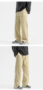 Detail of khaki wide-leg trousers featuring adjustable drawstring waist and side cargo pockets