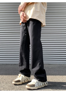 Outdoor shot of men's black double knee carpenter pants in a loose vintage streetwear fit