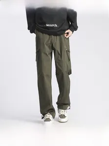 Detail view of olive green cargo pants with side pockets and a straight-leg fit design