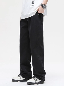 Men's loose white cotton jeans featuring a straight leg fit and adjustable button hem detail