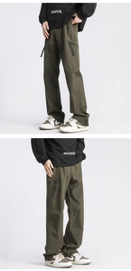 Detail of olive green cargo pants featuring utility pockets and durable fabric texture