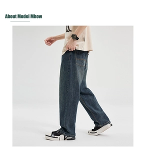 Detail view of baggy distressed denim jeans showing vintage wash and wide-leg fit for men