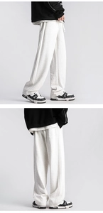Detail of wide elastic waistband with white drawstring on gray fleece jogger pants