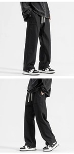 Detail of black wide-leg trousers featuring drawstring waist and large cargo side pockets