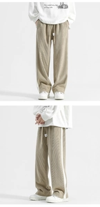 Detail view of khaki corduroy wide-leg pants with white side stripes and drawstring