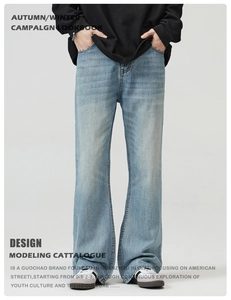Detail of light blue washed denim jeans with vintage whiskering and flared leg cut