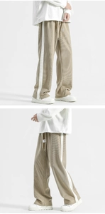 Detail of khaki corduroy trousers with side stripes and elastic waist with drawstring
