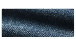 Close-up of blue washed denim fabric with detailed twill weave and natural texture