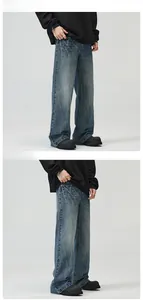 Detailed texture of american-style retro washed blue denim pants with fading and whiskering