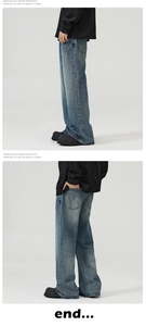 Detail of vintage blue wash denim jeans with cat-whisker texture and flared wide-leg cut