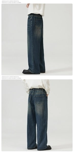 Detailed view of elastic waistband on dark blue vintage wash wide-leg denim jeans
