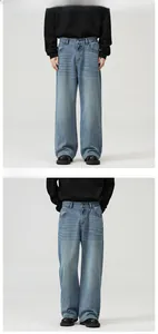 Detail showing elastic waist and washed denim texture of light blue wide leg jeans