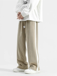 Vintage khaki wide-leg track pants with white side stripes and adjustable drawstring