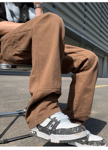 Close-up of brown heavy cotton canvas cargo pants with double-knee panels and workwear stitching