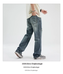 Detail shot of vintage washed flare jeans with distressed texture and gradient finish