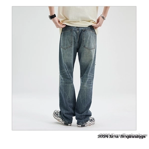 Macro detail of vintage washed blue denim pants with back pockets and fading effects