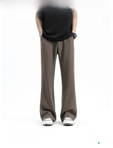 Close-up of premium coffee brown flared trousers with high-quality draped fabric