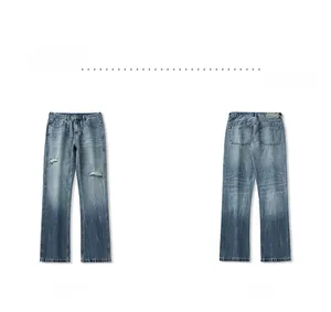 Detail of distressed light blue denim jeans with ripped effects and gradient wash