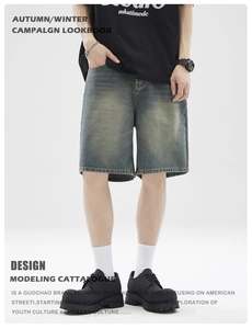 Detail shot of vintage washed denim shorts showing distressed texture and faded finish