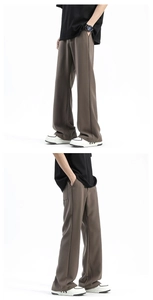 Detailed view of the smooth drape fabric and coffee brown finish on the relaxed pants