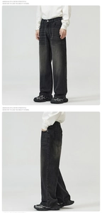Detail of loose-fit straight-leg denim jeans in vintage washed dark gray wash finish