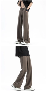 Detailed view of brown men's wide-leg dress pants with premium drape fabric