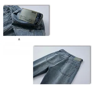 Detail of vintage leather patch and distressed rear pockets on washed blue flare jeans