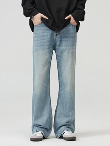 Men's light blue washed flared jeans in vintage American style with distressed finish