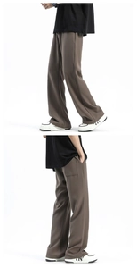 Detail showing the dark coffee straight leg pants with a drape finish and side stitching