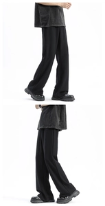 Detail of black wide-leg ice silk trousers showing fluid drape and high-street cut