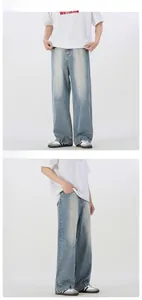 Detail view of light blue wide leg denim pants with vintage washed texture and loose fit