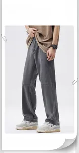 Detail view of gray loose fit trousers featuring distinctive horizontal seam stitching