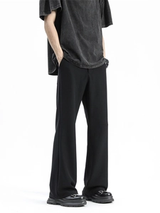 Men's minimalist black wide-leg trousers in high-drape fabric for a high-street aesthetic