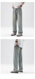 Close-up of light wash retro straight-leg jeans with vintage yellow faded finish
