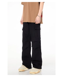 Vue détaillée du pantalon cargo noir avec de grandes poches à rabat latérales