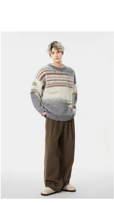 Detail of straight wide-leg trousers styled with a striped knit sweater and casual shoes
