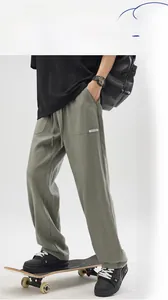 Detail of grey-green linen-textured casual pants with drawstring waist and cargo pockets