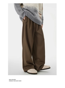 Close-up of high-quality brown wide-leg trousers with heavy twill fabric texture