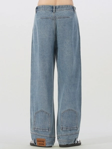 Back view of light blue straight denim jeans with retro pockets and leather logo patch