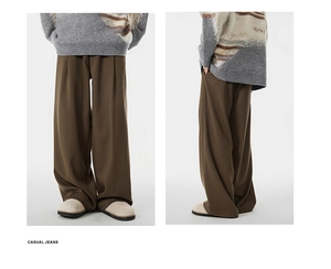 Detail view of dark brown wide-leg casual trousers with high-waist straight-cut drape design