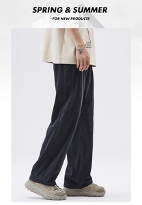 Side view of men's loose black straight-leg cargo pants with casual streetwear styling