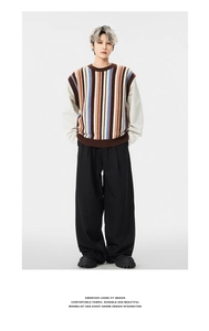 Detail of loose fit vintage American style striped knitted vest with ribbed hem and neckline